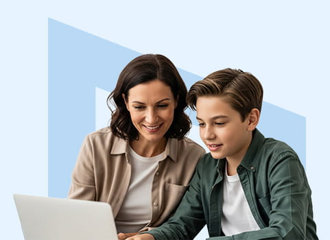 Mom and son sitting in front of white laptop computer.