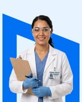 woman in blue scrubs and lab coat with latex gloves, clipboard, and safety glasses.