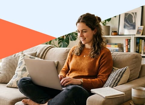 woman sitting on the couch on her laptop.