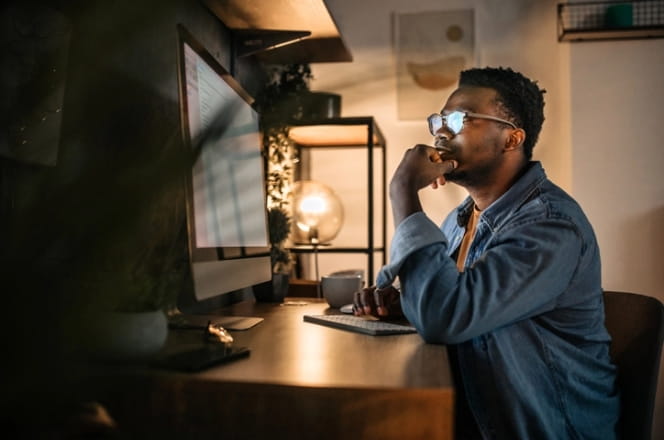 man looking at computer at home.