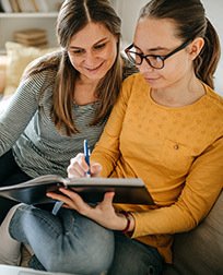 daughter and mother studying.