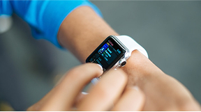 Photo of persons arm with  smart watch.