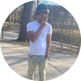 Ba’Sil S. 2025 Penn Foster High School grad, standing outside.