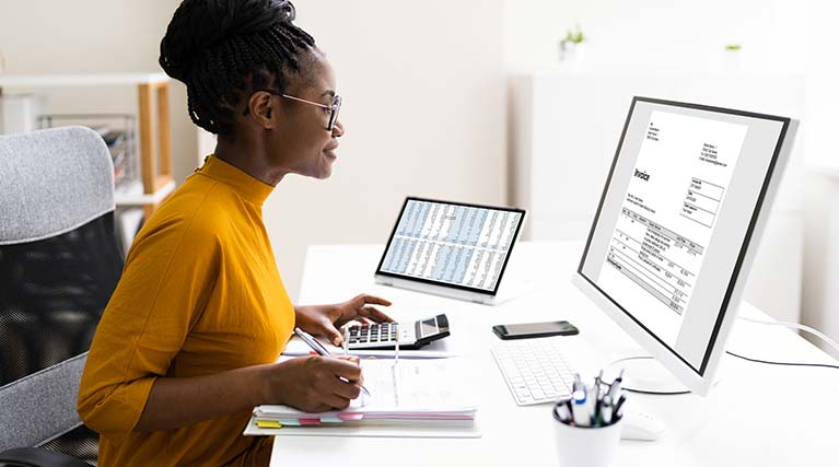 accountant working on desktop computer.