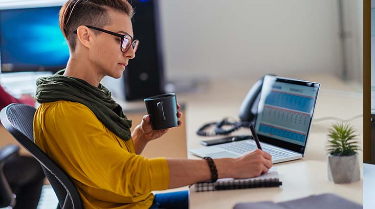 accountant taking notes at desk.