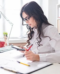 accountant using calculator at desk.