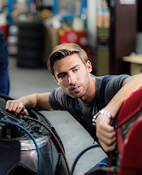 automotive HVAC technician working on vehicle.