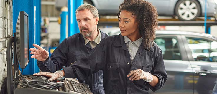 automotive technician working using a computer.