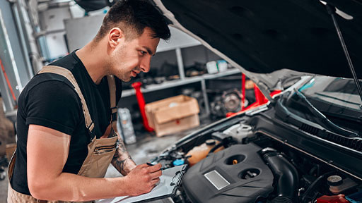 mechanic checking car engine..