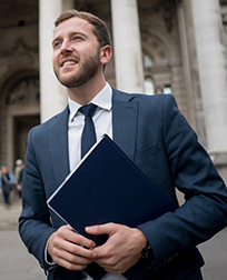 male criminal justice professional in front of courthouse.