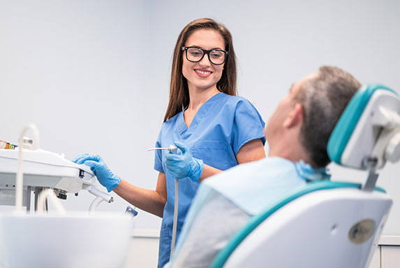 dental assistant with patient.
