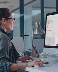 desktop publisher working on computer.