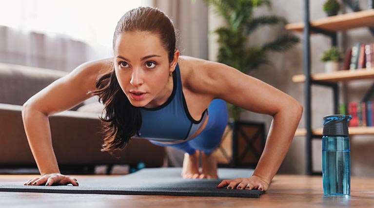 woman practicing yoga plank pose.