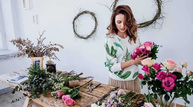 florist assembling bouquet.