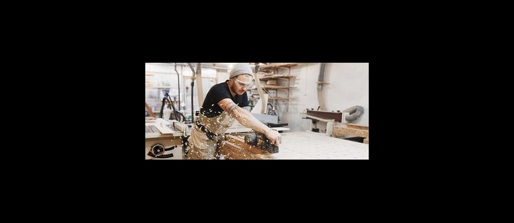 carpentry student using electric wood plane.