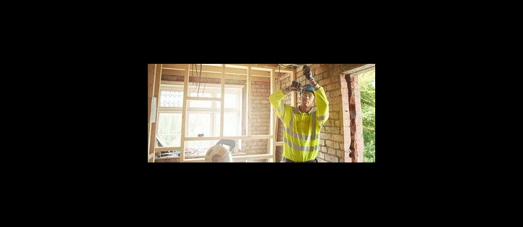 electrician working on home remodel electrical wiring.