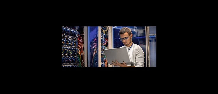 IT professional working on cable network in server room.