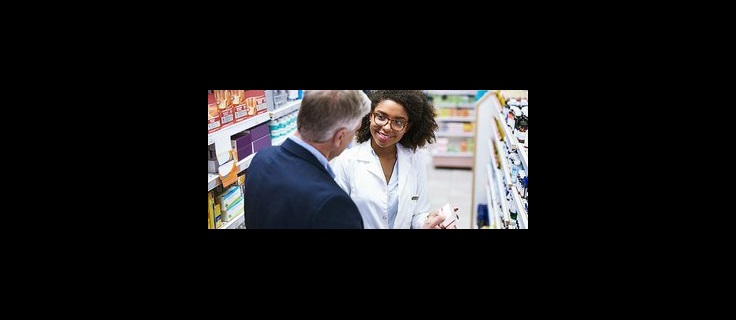 pharmacist assisting a customer.