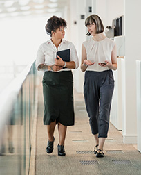 two human resource professionals talking at work.