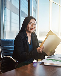 legal secretary opening folder at desk.