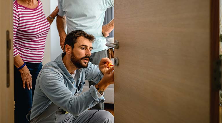 locksmith fixing door lock.