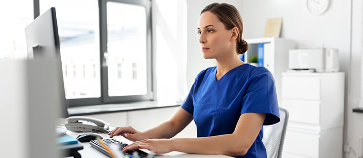 medical professional at computer.