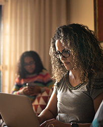 woman using laptop in living room.