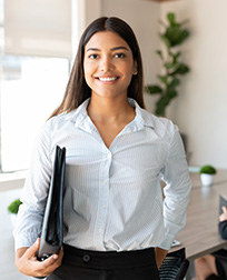paralegal with folder standing in office.