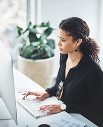 payroll clerk working at a computer.
