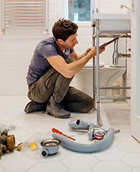 plumber fixing bathroom sink drain.