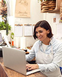 small business owner checking laptop.