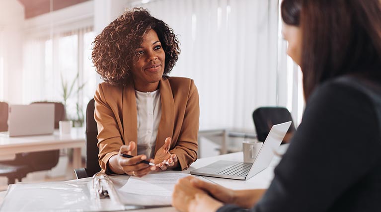 tax preparer at desk with client.