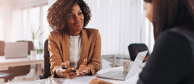 tax preparer at desk with client.