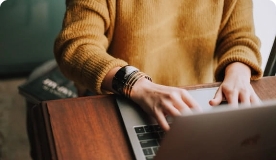 Person’s hands typing on laptop.