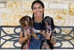 Penn Foster Vet Tech student holding 2 dogs. 