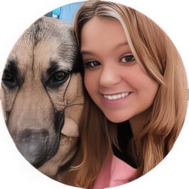 Penn Foster graduate, Heather, posing with large dog. 