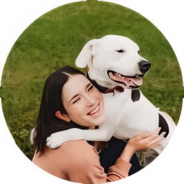 Penn Foster Vet Tech grad posing with white and black dog outside. 